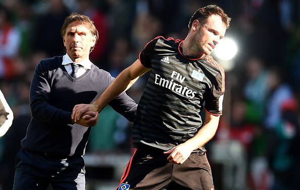 Hamburg's defender Heiko Westermann is helped by Hamburg's head coach Bruno Labbadia (L) after the German first division Bundesliga football match SV Werder Bremen vs Hamburger SV in Bremen, northern Germany, on April 19, 2015. Bremen won 1-0. AFP PHOTO / PATRIK STOLLARZ RESTRICTIONS - DFL RULES TO LIMIT THE ONLINE USAGE DURING MATCH TIME TO 15 PICTURES PER MATCH. IMAGE SEQUENCES TO SIMULATE VIDEO IS NOT ALLOWED AT ANY TIME. FOR FURTHER QUERIES PLEASE CONTACT DFL DIRECTLY AT + 49 69 650050. (Photo credit should read PATRIK STOLLARZ/AFP/Getty Images)